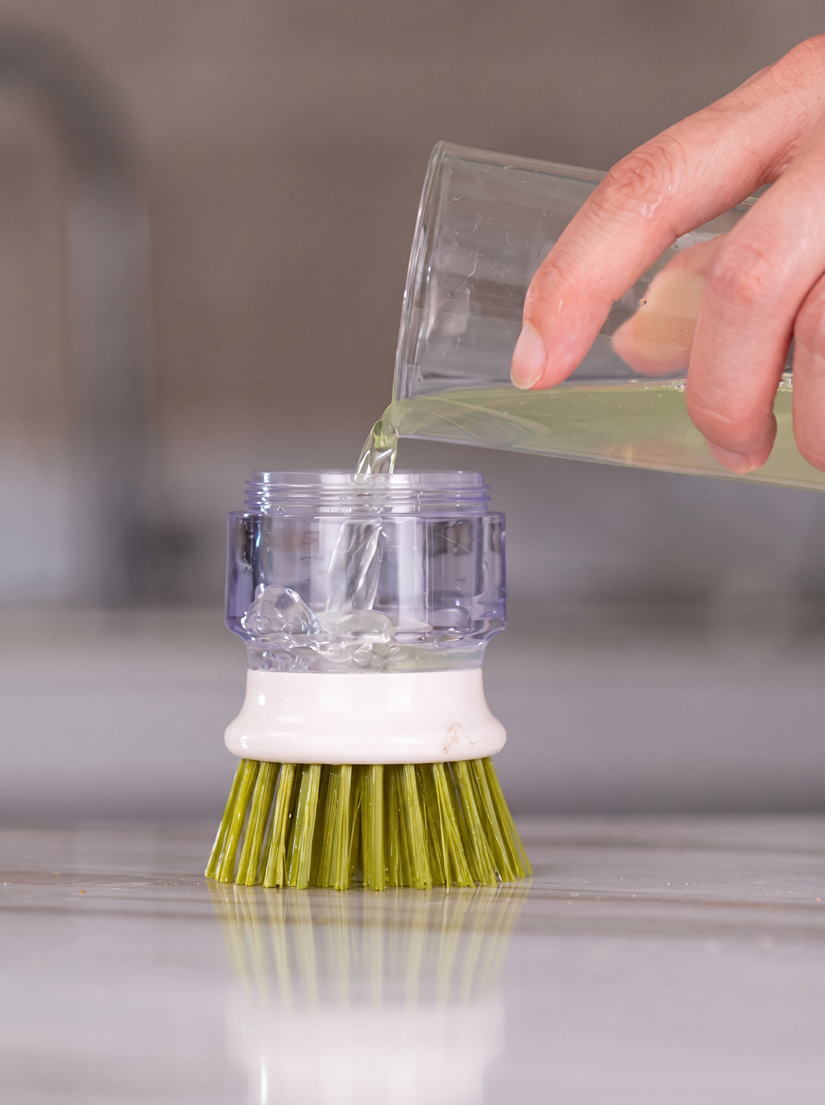 Pouring dish soap into the Smart Lumora ScrubPro reservoir